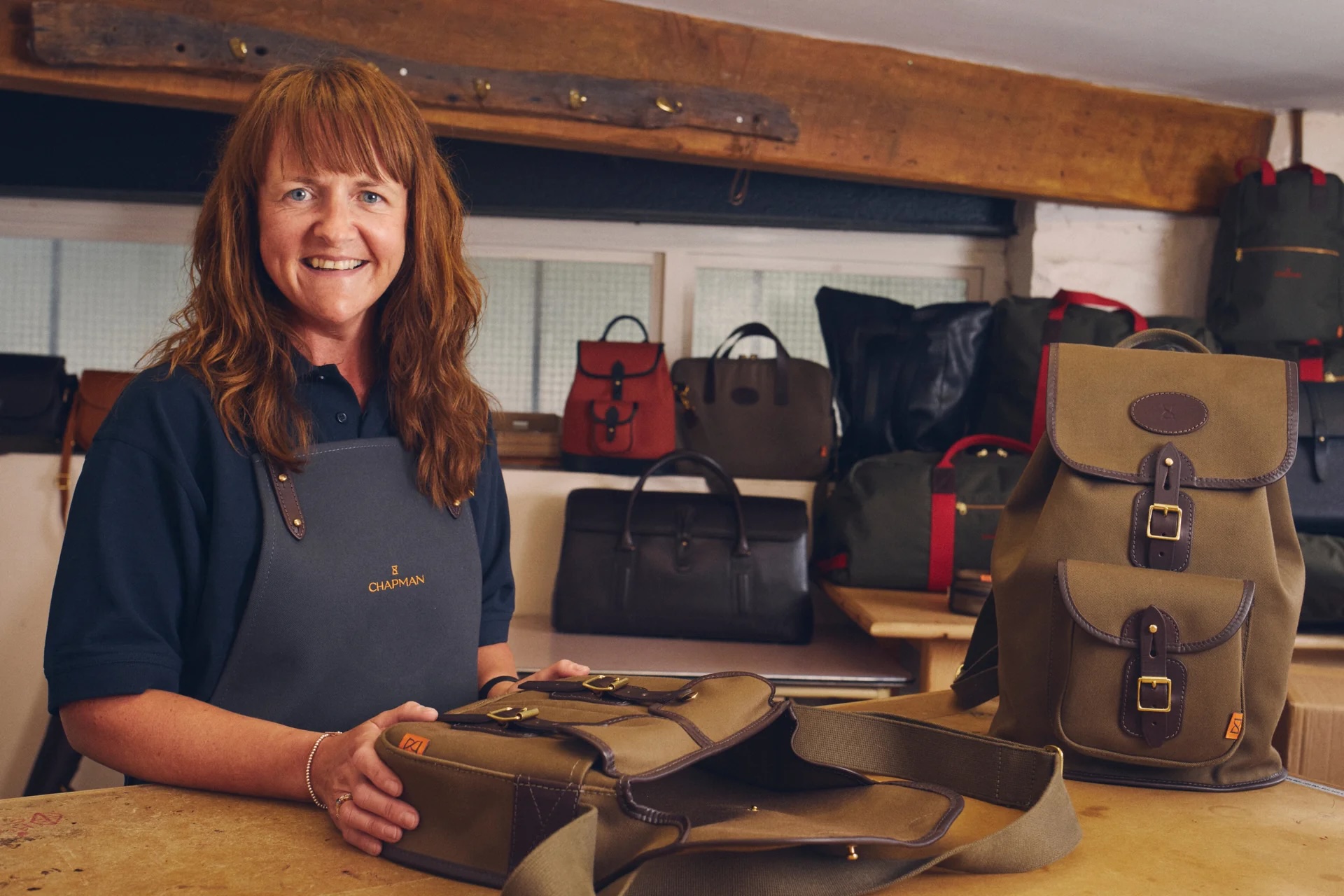 A Chapman craftswoman with the British brand's heritage bags in Carlisle.